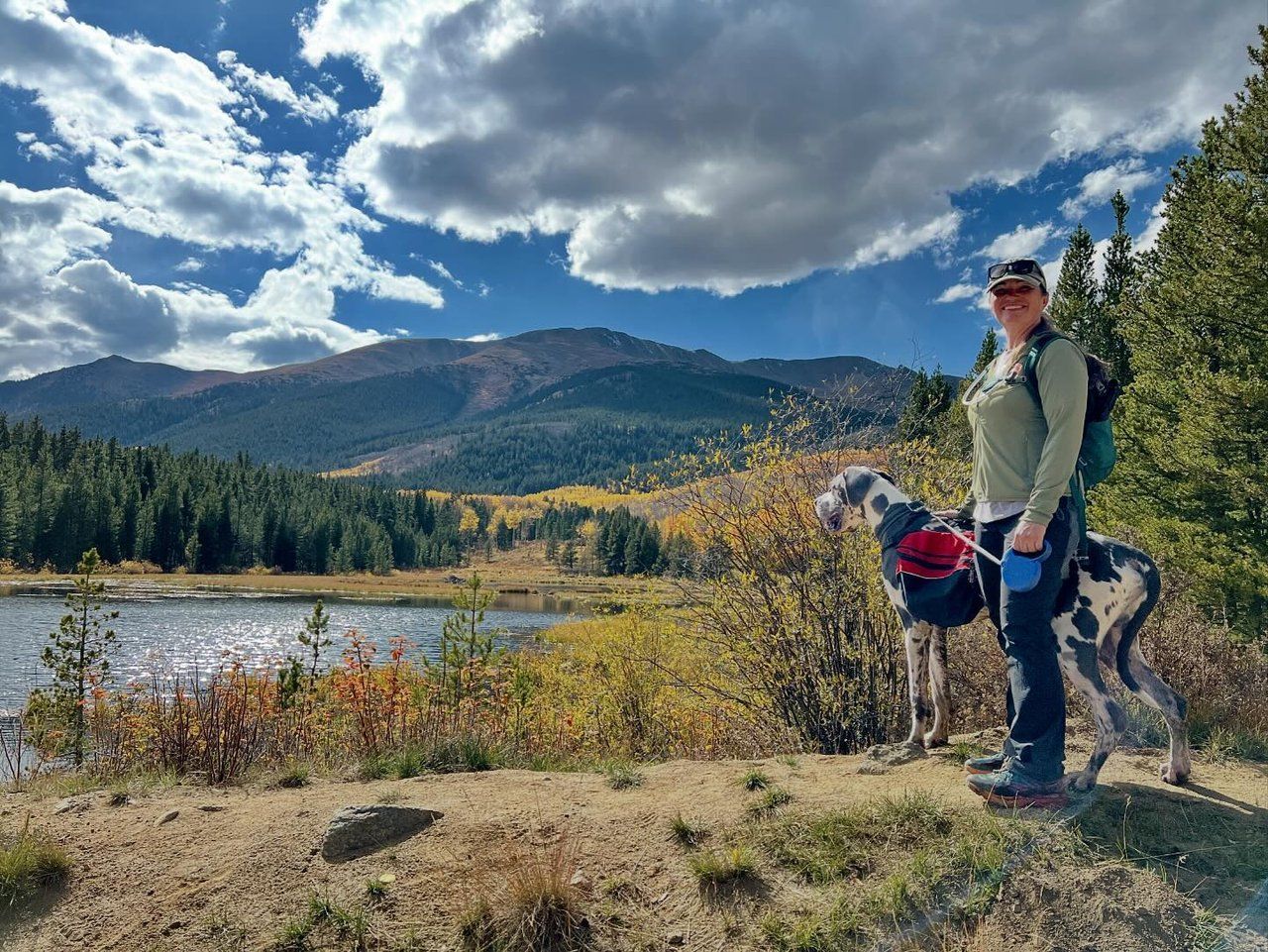 Woman with her dog by Twin Lakes in fall by @dykstrascience