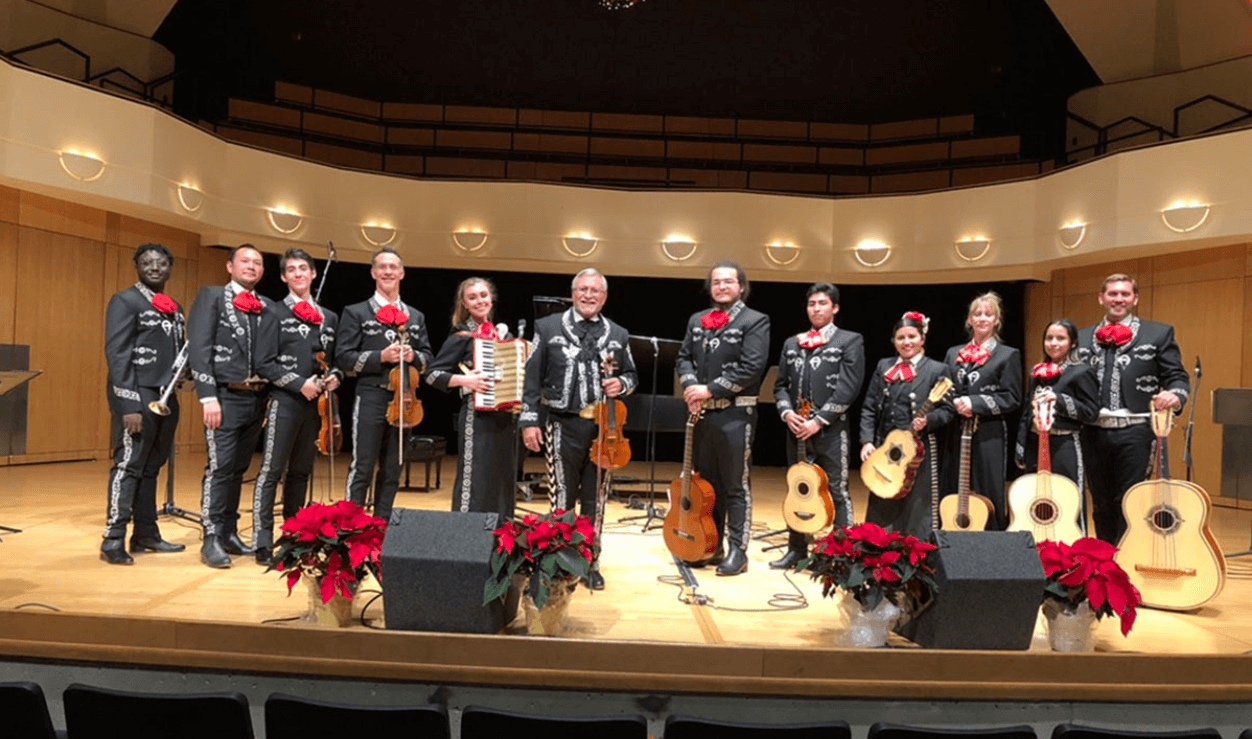 Members of the Mariachi Los Correcaminos de MSU Denver on stage with their instruments